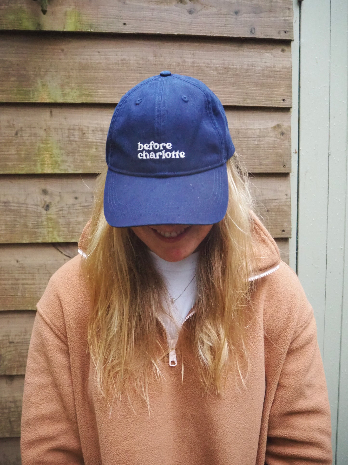 Maddi wearing a BC blue cap with 'before charlotte' text in white.