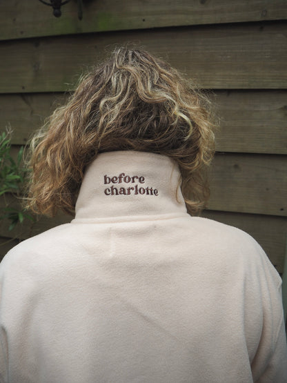 Sallie is wearing the Courchevel cream fleece 1/4 zip with 'before charlotte' embroidered on the back. 