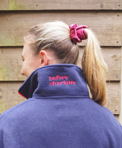 Maddi is wearing the Nantucket navy blue fleece 1/4 zip with 'before charlotte' embroidered on the back. 